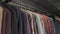 Row of men suit jackets on hangers in different colors. Men\'s jackets on hangers in the men\'s store