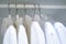 Row of men and women shirts on the hanger, hanging in the wardrobe