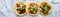 Row of mexican street tacos with carne asada and al pastor in corn tortilla wide banner composition