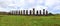 Row of Moai Stone Statues on Platform with Green Grass Foreground