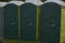 Row of mobile green bio toilets outside