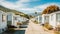 Row of mobile homes in a park with mountainous backdrop