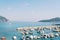 Row of moored boats along the pier overlooking the sea and mountains. Dubrovnik, Croatia