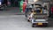 A row of motor tricycles - tuk tuk with resting driver