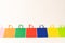 Row of multi colour canvas bags with copy space on white background