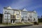 Row of multicolored townhouses under a blue sky