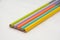 Row The multicolours wooden pencils  isolated in white background