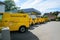 Row of multiple electric Volkswagen yellow vans with Deutsche post DHL logotype