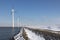 Row offshore windturbines along Ductch coast in winter with snow