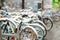 Row of old bicycles covered with snow after massive snowfall in New York City at wintertime.