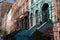 A Row of Old Colorful Brownstone Townhouses with Staircases on the Upper West Side of New York City