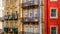 Row of old, colorful buildings with ornate balconies and tiles line a street in Porto, Portugal