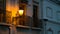 A row of old houses with balconies at night in Algarve southern Portugal lit only by a yellow street lamp