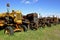 Row of old rusty tractors