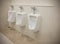 Row of outdoor urinals men public toilet room