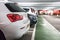 Row of parked cars inside a covered car park with pedestrian walkway