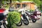 A row with parked motorcycles in a camping area with a