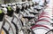 Row of parked vintage bicycles bikes for rent on sidewalk