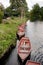 A row of parked wooden rowing boats on river country