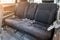 Row of passenger rear seats upholstered in dark gray dry-cleaned fabric; pre-sale preparation of an old Japanese car