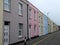 Row of pastel colour terraced houses