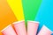 Row of pink paper drinking cups on multicolored pinwheel background. Funky retro style. Birthday party fest celebration kids fun