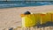 Row of Plastic Garbage Bins Deployed on Seashore Beach Sand