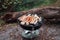 Row of pork and beef bratwurst grilling over a barbecue fire on the summer vacation