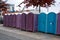 A row of portable rent toilets