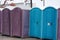 A row of portable rent toilets