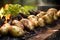 row of potatoes baking around the edge of a fire