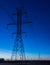 Row of power line towers during blue hour