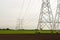 Row of power pylons in an agricultural area