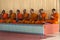 Row of praying Buddhist monks on Ko Samui Island, Thailand