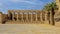 Row of ram-headed sphinxes in front of a row of columns in the first courtyard of the Temple of Amun at Karnak near Luxor, Egypt.