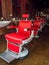 A row of red barber shop chairs.