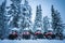 Row of red and black snowmobiles in winter Lapland