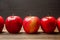 Row of red glossy apples on wood table black background. Banner for Thanksgiving autumn season healthy diet