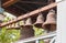 Row of religious bells in park. Bronze ornament bells botanical