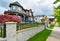 Row of residential houses with concrete pathway along the front yard. Metal fence in front of residential house