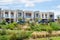 A row of residential townhouses with family cars parked at the front. Modern Australian homes in a new suburb.