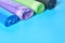 Row of rolls of disposable plastic garbage bag on blue background