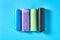Row of rolls of disposable plastic garbage bag on blue background. Top view
