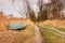 Row rusty boat the grass shore during rainy day