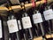 Row of Saint-Estephe Bottles, Classified Growths bottles French wines display for sell in the supermarket shelves