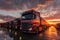 A row of semi trucks parked in a parking lot on sunset. Many trucks in panoramic image