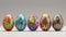 A row of seven vibrant, intricately decorated Easter eggs displayed on a textured surface