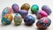 A row of seven vibrant, intricately decorated Easter eggs displayed on a textured surface