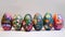 A row of seven vibrant, intricately decorated Easter eggs displayed on a textured surface