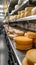 Row of Shelves Filled With Various Cheeses